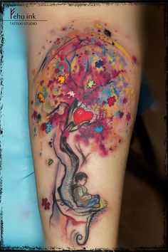 a colorful tattoo with an image of a tree