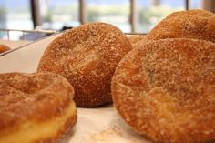 some sugared donuts are sitting on a tray