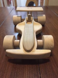 a wooden toy car sitting on top of a table