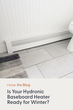 a white toilet sitting in a bathroom next to a radiator with the words is your hydronic baseboard heater ready for winter?