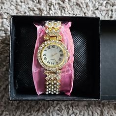 Brand New Gold And Crystal Embellished Watch With Roman Numerals. Makes A Beautiful Gift! Comes In A Gift Box Elegant Diamond Watch With Rhinestones For Gift, Elegant Diamond Watch With Rhinestones As Gift, Elegant Metal Watches With Bling, Rhinestone Watches Perfect As Gifts, Rhinestone Watches With Round Dial, Party Watches With Rhinestones, Gold Party Watches With Rhinestones, Elegant Embellished Metal Watches, Gold Rhinestone Party Watches