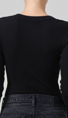 Designed from a form-fitting rib, this versatile henley can be worn fully buttoned or undone for a more relaxed look. This fit is true to size. Looks Like: Clean, dark blackFeels Like: Ultra-soft, ultra-supportive organic cotton rib with a hint of stretch that holds the body Body Length: 21 1/2"Shoulder to Shoulder: 13"Sleeve Length: 24 1/2"Model is 5'10" and wearing a size SmallFabric: 49% Organic Cotton 49% Tencel Lyocell 2%SpandexCare Instructions: Machine wash cold inside out with like color Hair Socks, Brighton Jewelry, Henley Shirt, Fall Baby, Loungewear Shorts, Anklet Jewelry, Henley Shirts, Scarf Hairstyles, The Body