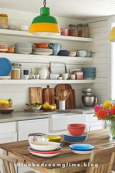 the kitchen is clean and ready to be used for dinner or desserts, with colorful plates on the table