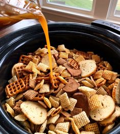 a crock pot filled with cheetos and waffles being poured into it