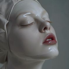 a white mannequin head with closed eyes