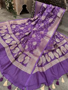 Beautiful and soft cotton silk Purple Banarsi dupatta finished with pretty tassels. Purple Cotton Silk Pallu Dupatta, Purple Cotton Silk Dupatta With Pallu, Purple Cotton Silk Dupatta With Pallu Detail, Purple Cotton Silk Dupatta For Diwali, Anarkali Style Dupatta With Latkans, Semi-stitched Cotton Silk Purple Dupatta, Festive Dupatta With Latkans In Traditional Drape, Festive Anarkali Dupatta With Latkans, Eid Dupatta With Latkans