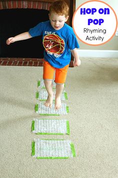 a young boy standing on top of a rug with the words hop on pop in front of