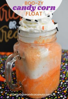 boo - y candy corn float in a mason jar with whipped cream and sprinkles