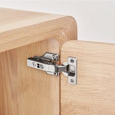 a close up of a wooden cabinet with metal latches