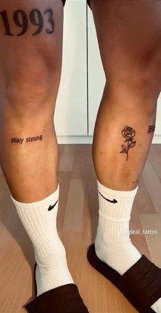 two people with tattoos on their legs and one has a rose tattooed on the leg