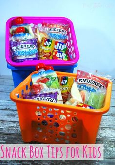 two plastic baskets filled with snacks sitting on top of a wooden table