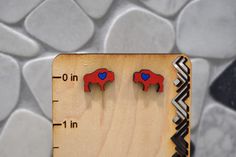 Let's go Buffalo! The perfect earrings to finish your outfit for the next big game!  Our earrings are made out of a variety of different woods which could be Mahogany, Cherry, or Sapele. All earrings have been designed, printed, painted and sealed by me! Since these earrings are handmade, each pair may have slight variations from the other. After I print the earrings, I hand paint with acrylic paint and seal with clear Rustoleum to preserve the earrings. Due to the earrings being made out of woo Lets Go Buffalo, Bills Mafia, Buffalo Football, Football Earrings, Gifts For Football Fans, Hand Paint, Big Earrings, Red Paint, Lets Go