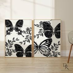 two black and white butterflies are on the wall