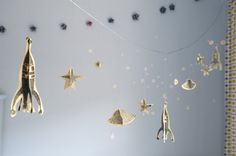 an image of a mobile with stars and rockets hanging from the strings in the room