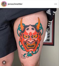 a man with a tattoo on his leg that has an image of a demon in it