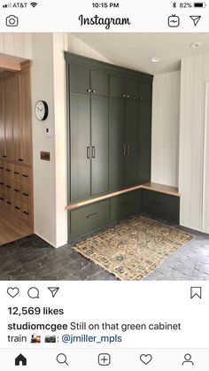 an empty room with green cabinets and a rug on the floor