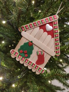 a christmas ornament hanging from a tree with stockings and stocking on it