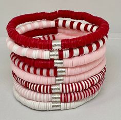 a stack of red and white striped bracelets