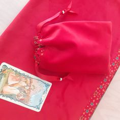 a red bag with a card on top of it