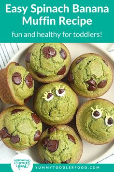 a white plate topped with green muffins covered in chocolate chips and smiling faces