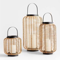 three bamboo lanterns with black handles on each one and two smaller ones in the middle