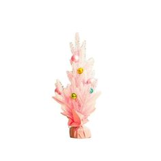 a pink vase filled with lots of different colored decorations on top of a white surface