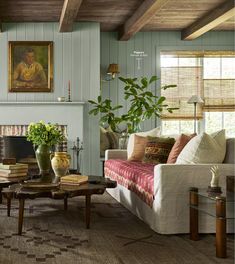 a living room filled with furniture and a fire place in front of a painting on the wall