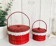 two red baskets sitting on top of a white table