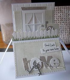 a close up of a card on a table with a key and window in it