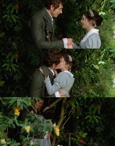 there are two people that are kissing each other in front of some trees and flowers