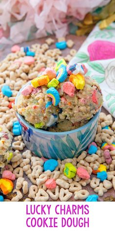 lucky charms cookie dough in a bowl with cereal scattered around it and the title overlay reads lucky charms cookie dough