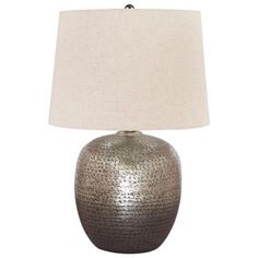 a lamp that is on top of a table with a white linen shade over it