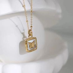 "Vintage Butterfly Necklace, Butterfly Square Shell Pendant, Butterfly Stainless Steel Gold Necklace for Women. Square butterfly Pendant Introducing our enchanting \"Vintage Butterfly Necklace\" featuring a Butterfly Square Shell Pendant. This delicate piece is crafted with stainless steel and adorned in gold, creating a timeless accessory for women. The square butterfly pendant adds a unique charm to elevate your style. Embrace the beauty of nature with this vintage-inspired necklace - a perfect blend of elegance and sophistication. WHAT'S INCLUDED: * Handmade Item * Comes in a small box, the ideal gift for Mom/ for her * Comes in color - Gold. SPECIFICATIONS ♡ Necklace length: 55 cm ♡ Material: Stainless Steel and Gold ♡ All products are safe for sensitive skin ♡ High quality materials u Gold Necklace For Women, Necklace Butterfly, Gold Pendant Jewelry, Gold Necklace Women, Vintage Butterfly, Timeless Accessories, Butterfly Necklace, Butterfly Pendant, Steel Necklace