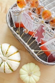 pumpkins and gourds are sitting on the table next to some candy bars