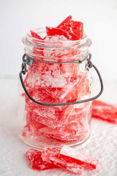 a glass jar filled with red gummy bears