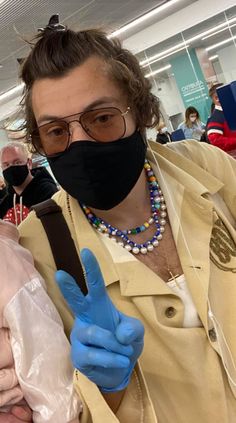 two people wearing face masks and gloves at an airport