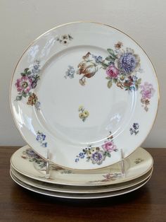 a stack of plates sitting on top of a wooden table