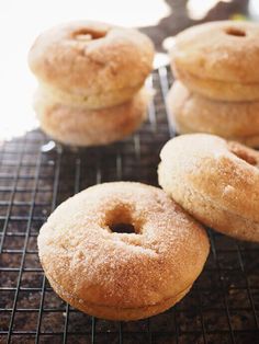 four donuts sitting on top of a cooling rack