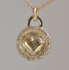 "Gold and Diamonds Necklace, a unique handmade piece, a perfect gift idea for the one you love. 14k solid gold disc pendant, perfect love gift for the one you love, a perfect gold gift for wife or for daughter. Heart round pendant 1.2 c\"m * 1.1 m\"m 14k solid gold with 16 small white Diamonds and 14k gold chain. A beautiful heart sticks out on the center of a naive gentle pendant and a circle around. 16 Diamonds are set around in an antique style I can set small gemstones or diamonds on this ci One Of A Kind Heart Jewelry For Anniversary, Yellow Heart-shaped Jewelry For Valentine's Day, One Of A Kind Gold Jewelry As A Gift, One Of A Kind Gold Jewelry For Gift, One-of-a-kind Gold Jewelry As A Gift, Yellow Gold Heart Pendant Necklace For Gift, Yellow Gold Necklaces With Heart Detail As Gift, Yellow Gold Necklace With Heart Detail As Gift, Yellow Heart Pendant Jewelry For Anniversary