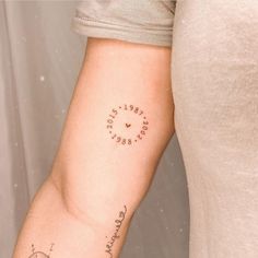 a woman's arm with a clock on it and words written in cursive writing