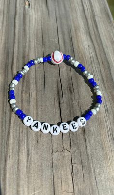 a bracelet with the word yankees on it and a baseball ball sitting on top of it