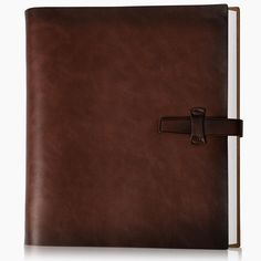 an open brown leather book with a cross on the cover