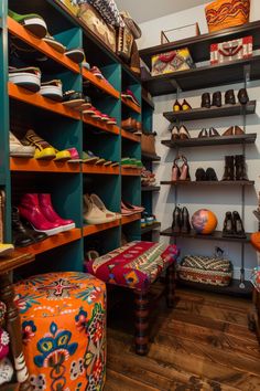 a room filled with lots of different types of shoes and footwear on shelving units