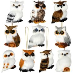 an assortment of owl ornaments hanging from strings on a white background with clippings