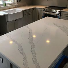 a kitchen counter with white marble on it