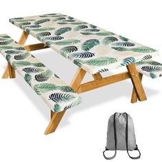 an outdoor table with two benches and a drawsack bag