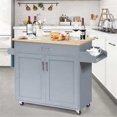 a kitchen island cart with food and wine on it in the middle of a room