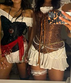 two women dressed in costumes taking a selfie