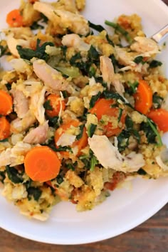 a white plate topped with rice and veggies on top of a wooden table