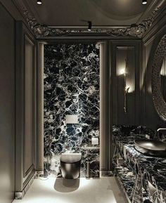 a black and white bathroom with marble walls